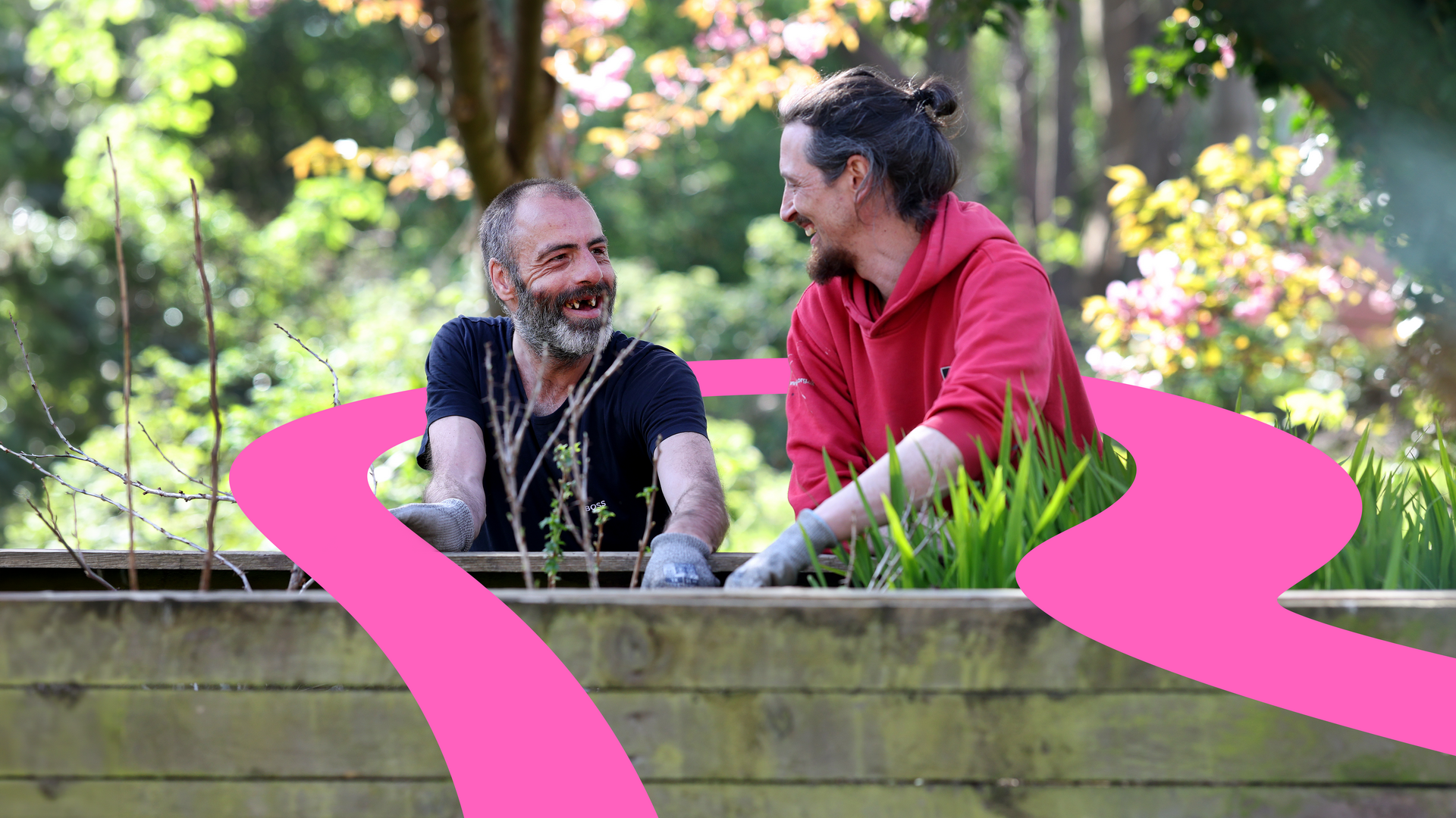 A member of Riverside staff works with a customer to plant some flowers