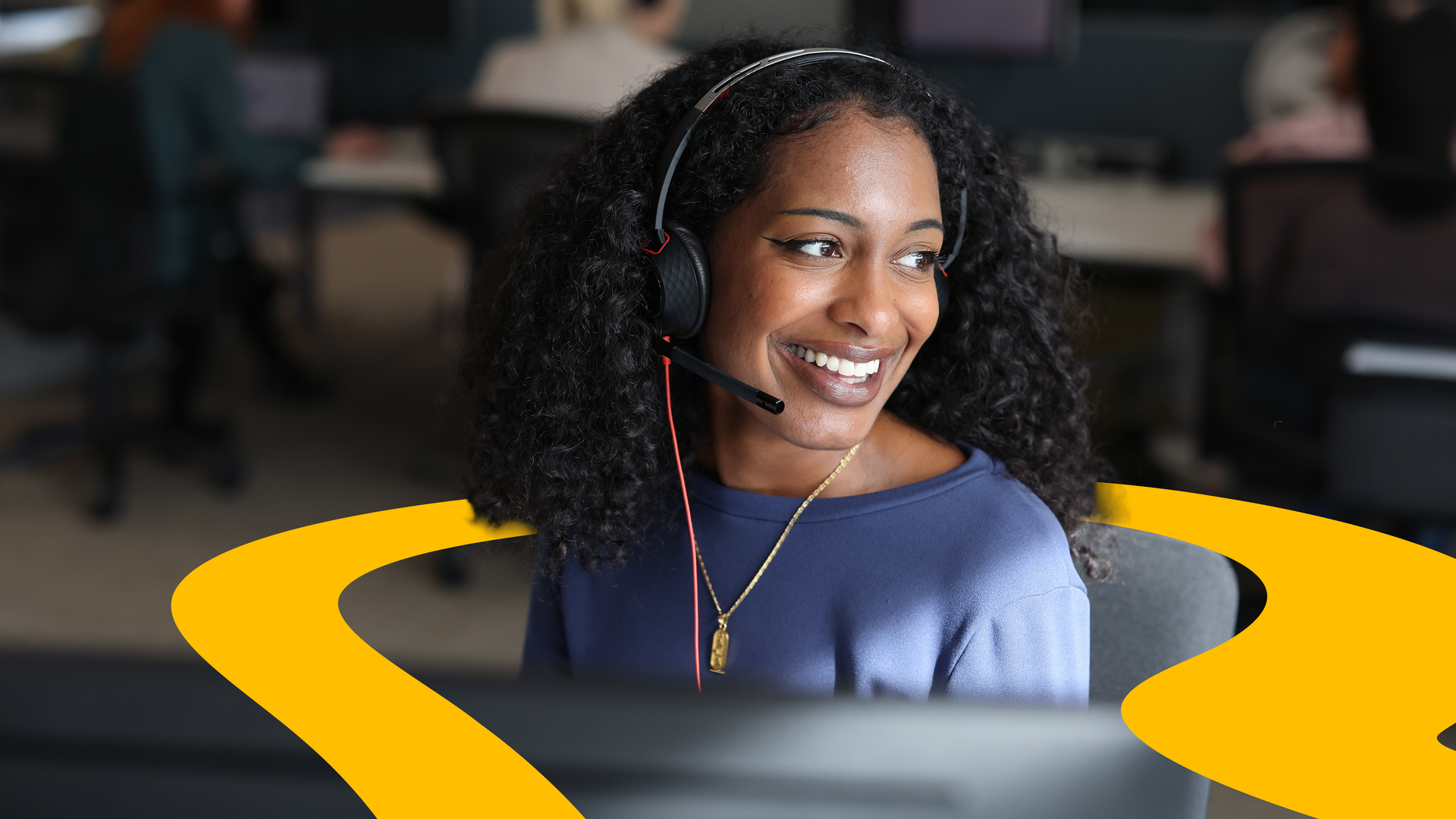 Customer service adviser taking a call in a contact centre.