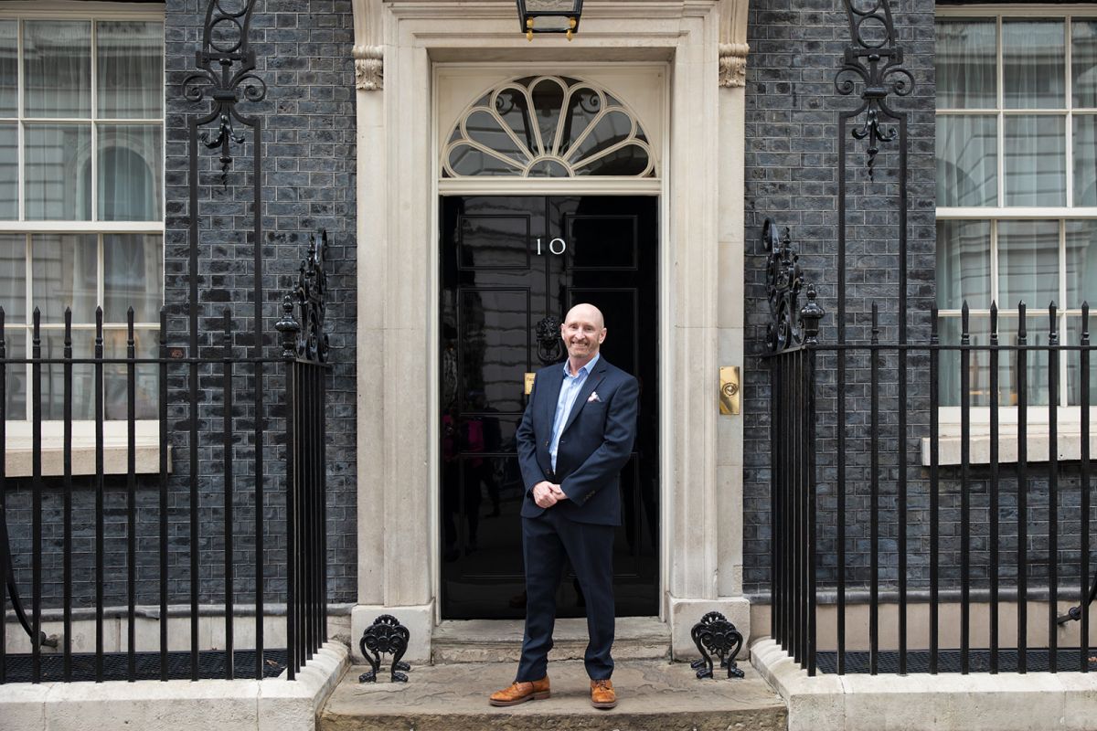 A person standing outside a 10 Downing Street