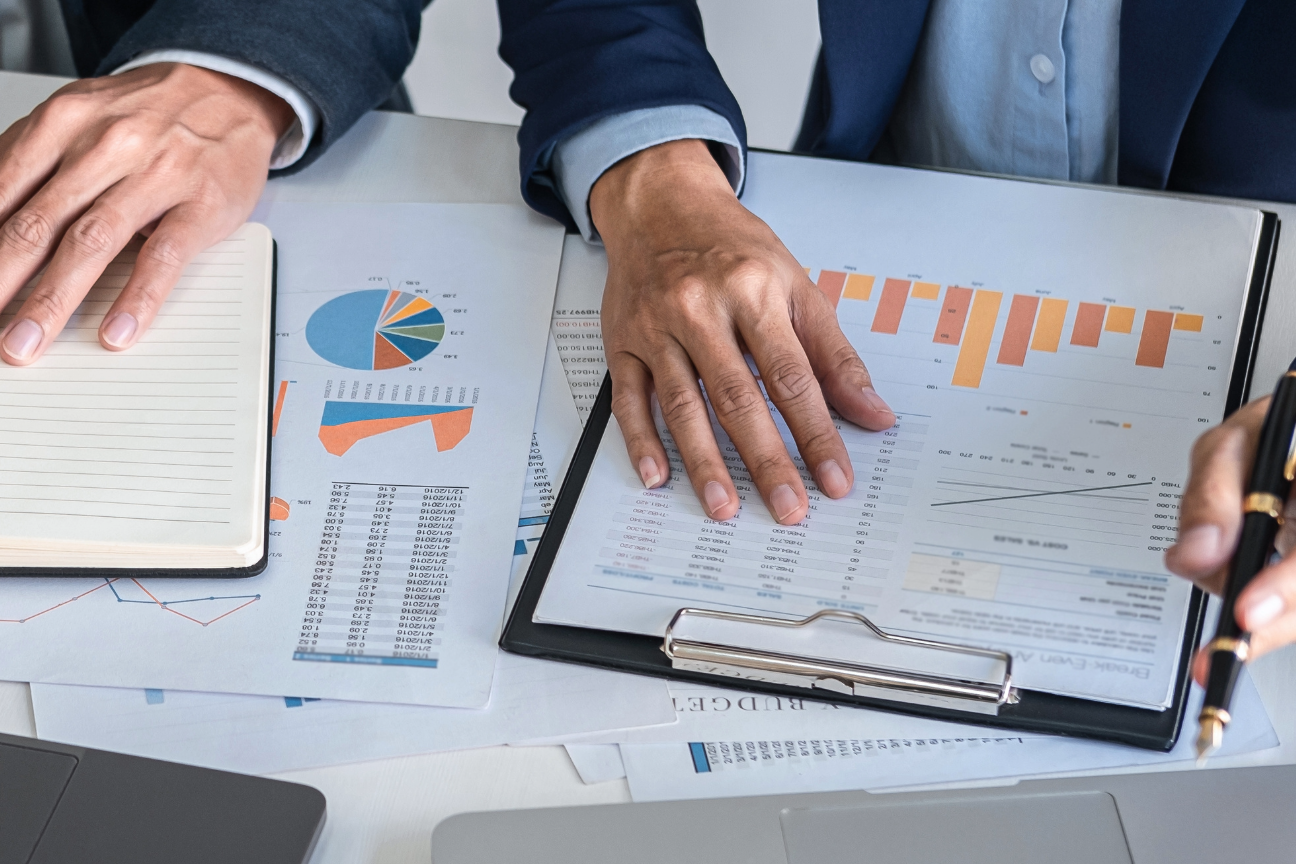 Financial documents and charts being reviewed during a treasury committee meeting.