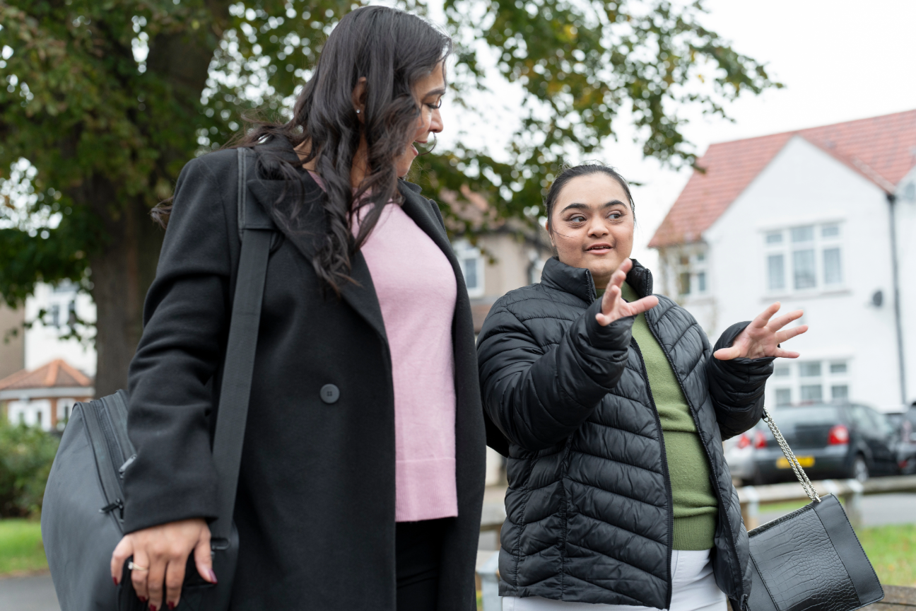 Housing colleague talking with a resident in their neighbourhood.