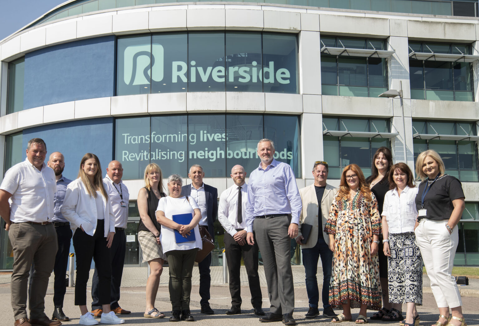 Colleagues standing outside Riverside Speke Head office