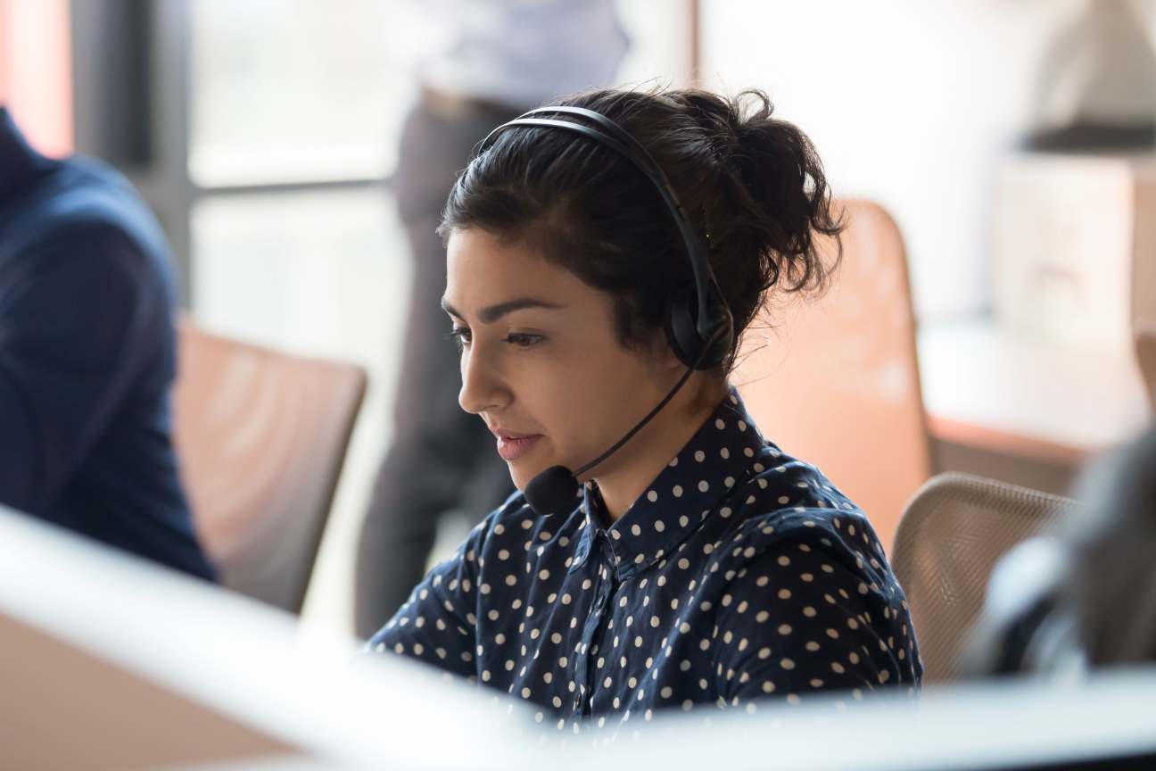 woman with headphone set on in call centre