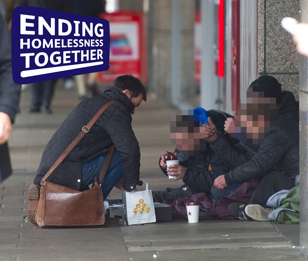Ending Homelessness Together Graphic of man helping homeless person