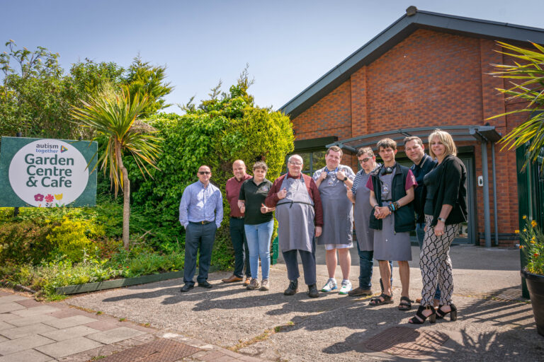 Staff and residents outside the garden centre and cafe