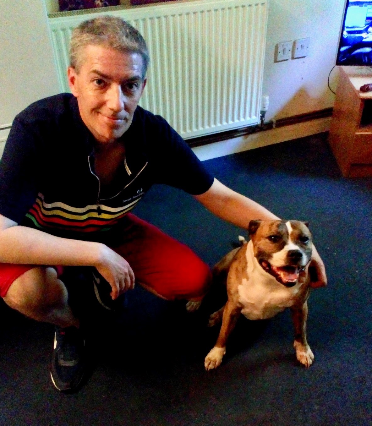 Resident with dog in his home