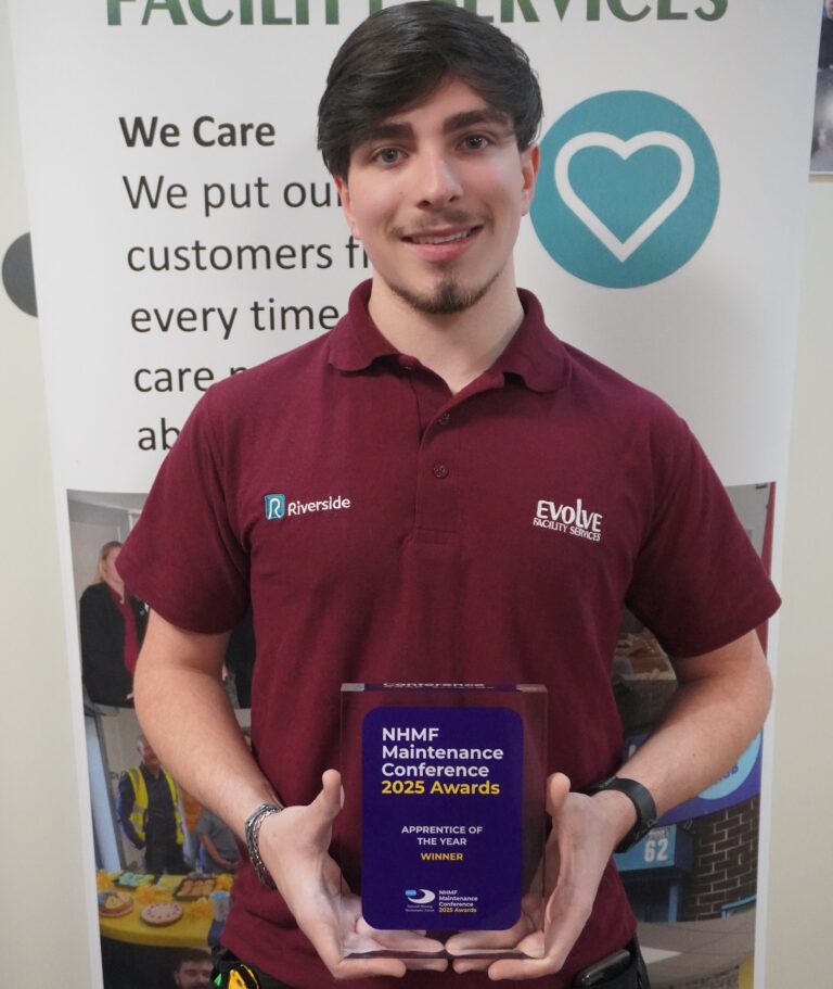 Apprentice holding the NHMF Maintenance Conference 2025 Apprentice of the Year award, wearing Riverside and Evolve Facility Services uniform.