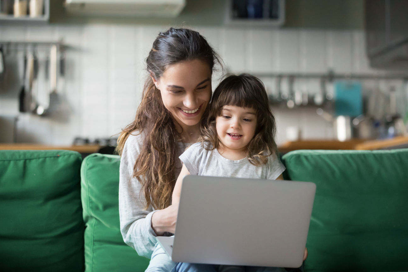 woman with child looking on computer at home