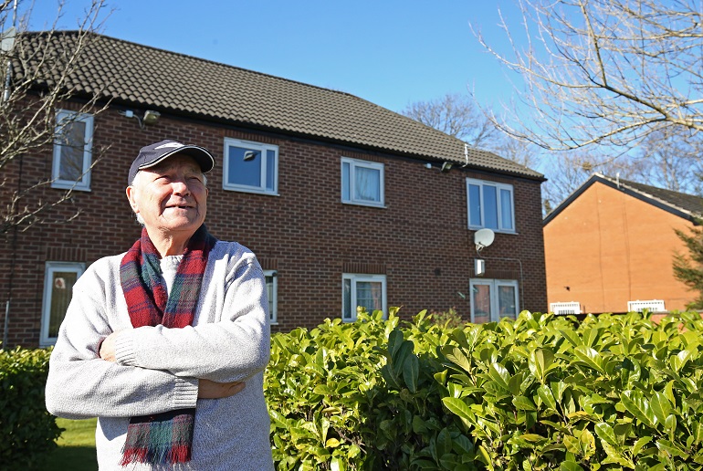 Man outside James Court, Retirement Living apartments in Gorton, Manchester