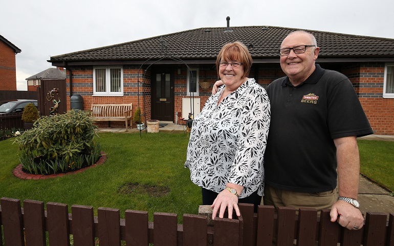 Couple inn front of Overbeck Close, Riverside's Retirement Living bungalows in Wigan