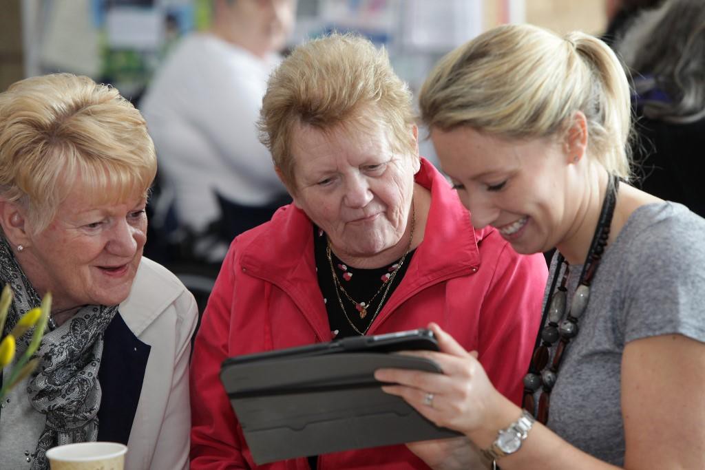 Tenants learn how to use a tablet computer