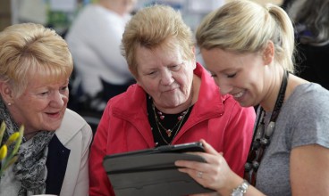 Tenants learn how to use a tablet computer
