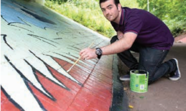 Artist Gareth Arrowsmith puts the finishing touches to the mural