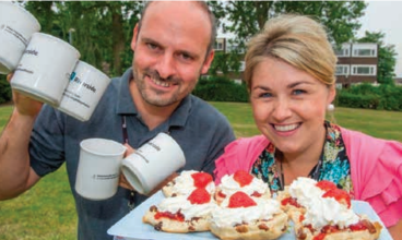 Riverside’s Karl Delamar and Jackie Ulring get ready to dish out mugs of tea and scones at the afternoon tea party