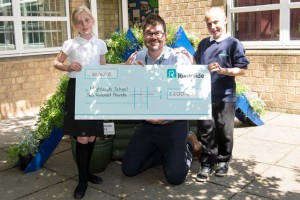 Riverside's Lee Bailey presents cheque to pupils at Highlands School