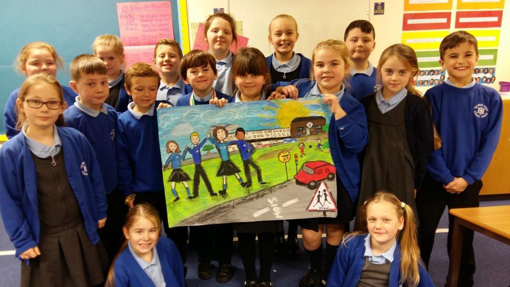 Youngsters from Holy Spirit Primary School show off their design for the welcome sign