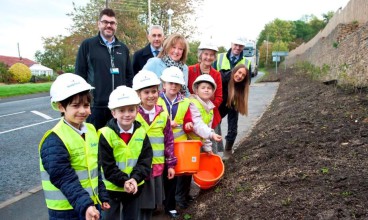 Youngsters from Mickley First School help representatives from Riverside, Keepmoat and County Councillor Anne Dale plant wildflower seeds