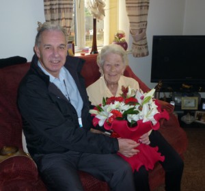 Neighbourhood Services Manager Jeff Allen presents Mary with flowers to celebrate her birthday