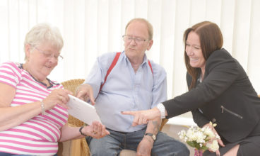 Alison Halstead, Riverside's Head of Retirement Living, and customers looking at iPad usage