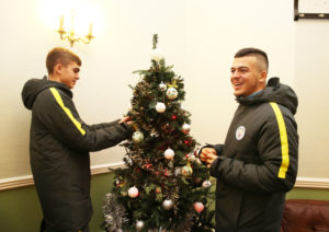 Manchester City Under-18s players decorate a tree in Newbury House