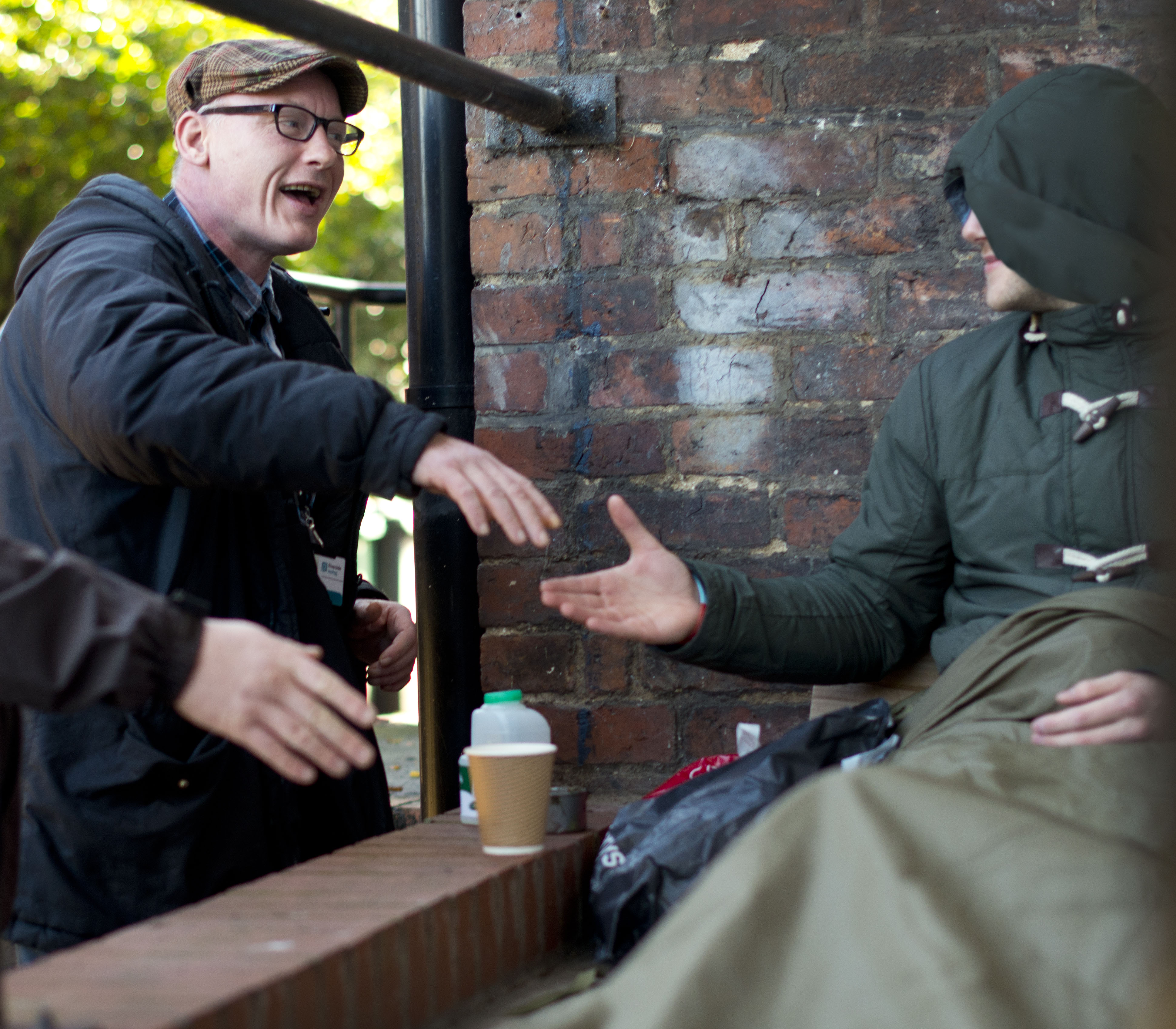 A Riverside Care and Support outreach worker talks to a rough sleeper.