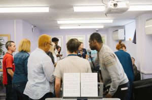 Residents and staff at King George's Hostel in Westminster, at a singing workshop.