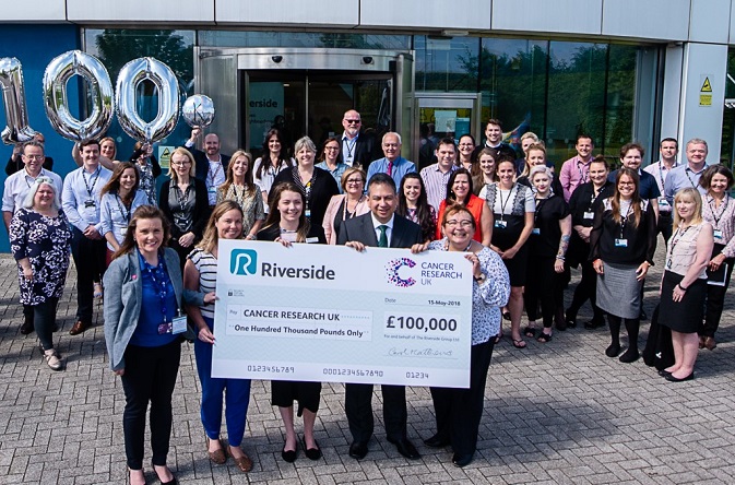 Riverside present CRUK with £100,000 cheque raised by staff.