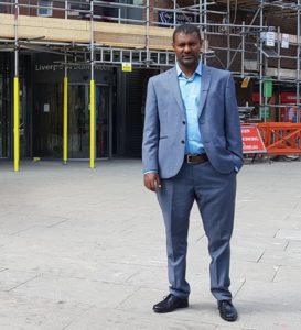 Riverside tenant Mosissa Hunde graduating in front of LJMU.