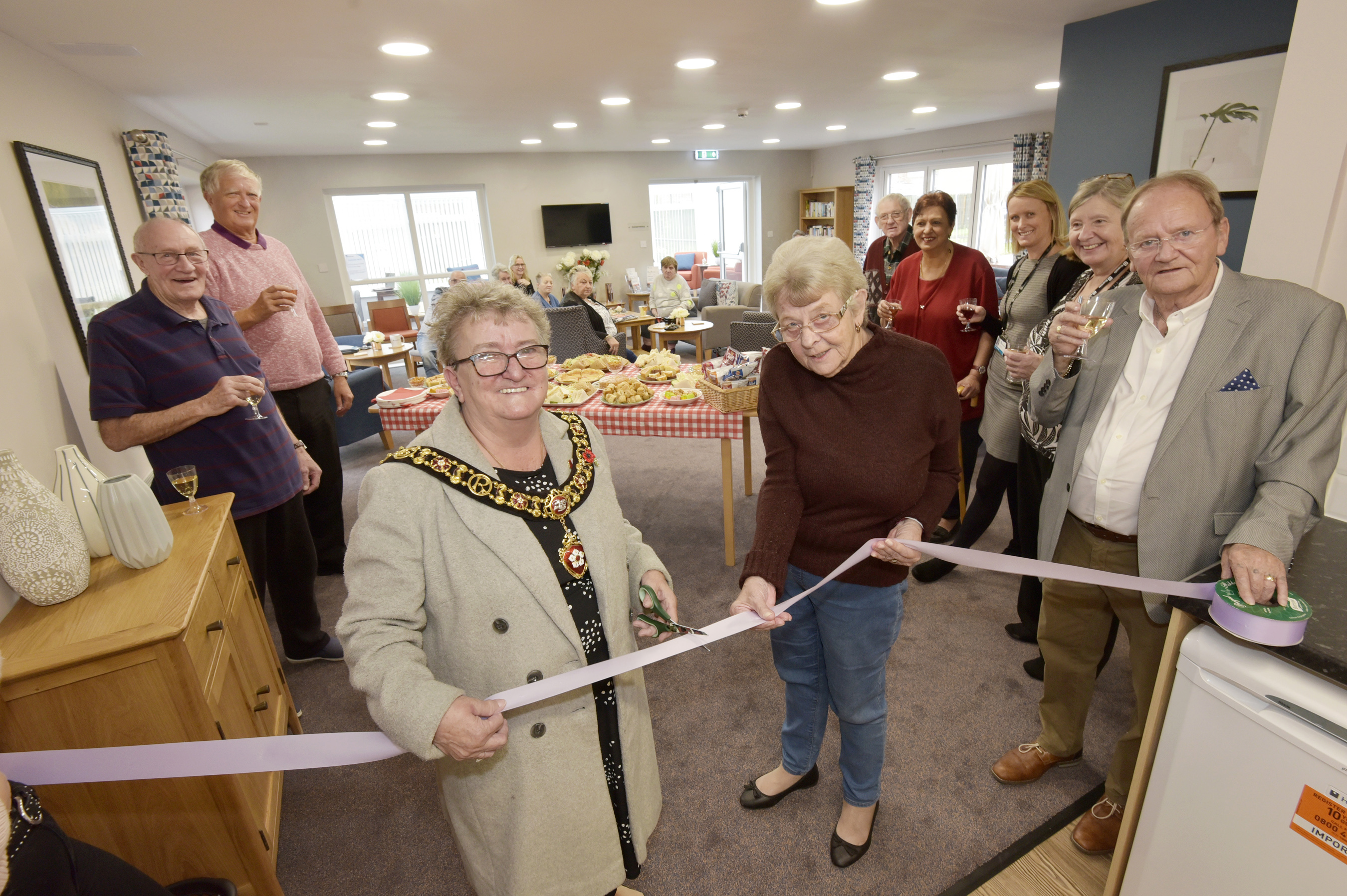 Lord Mayor of Leicester, Cllr Annette Byrne, cutting the ribbon with The Quadrant residents in the newly refurbished lounge.