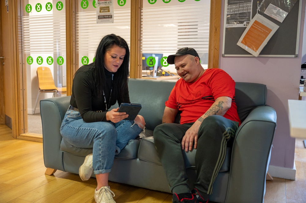 Staff and customers chatting on sofa at The Crossings, Hull