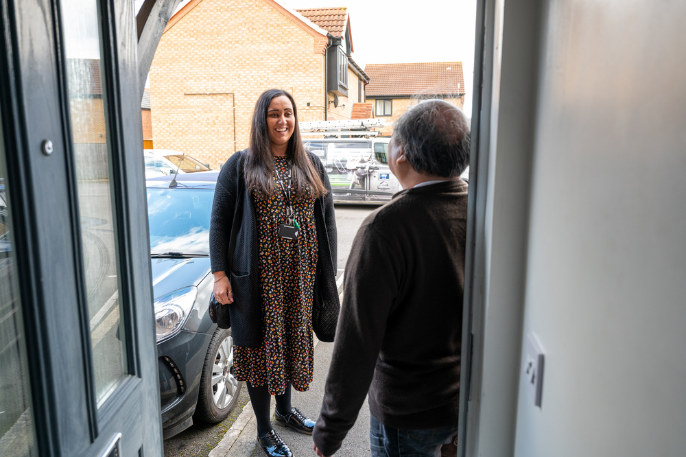 Staff visiting customer at housing as part of Floating Support at The Crossings, Hull.