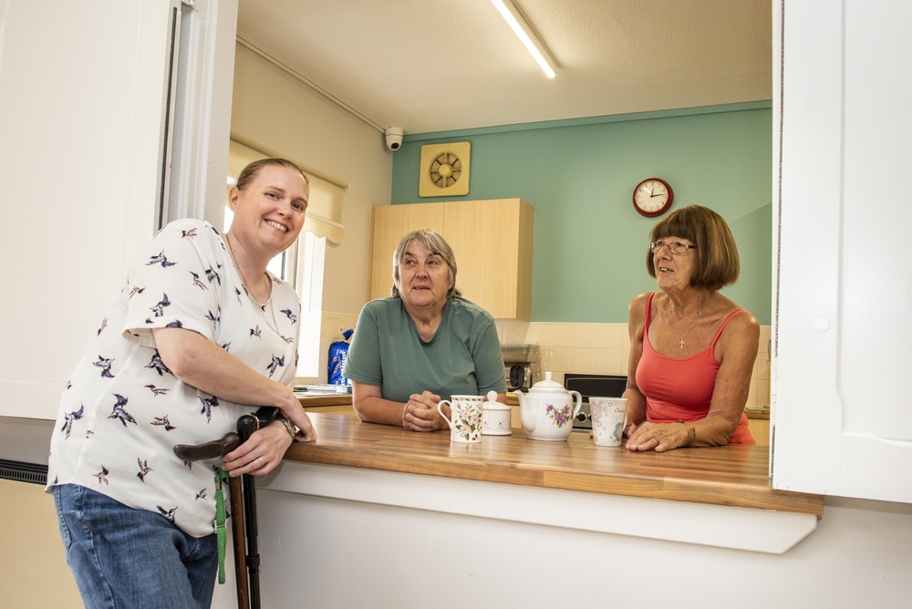 A Retirement Living Co-ordinator and customers sharing a cup of tea in Hob House Court based on the Wirral.