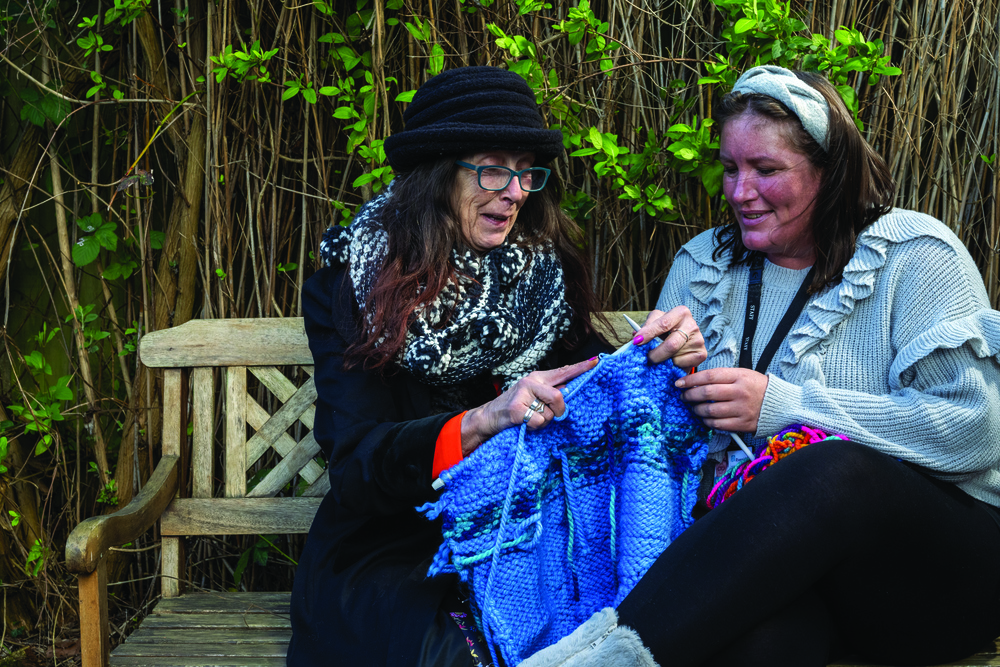 Customer at No.5 HUB in Guildford Surrey knitting in the garden