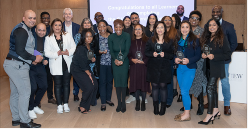 A group of people standing together and each holding an award from the G15 Accelerate programme.
