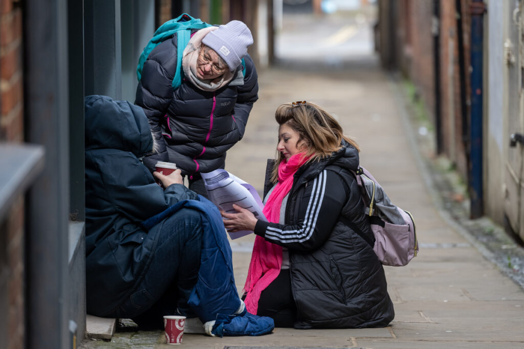 Riverside outreach workers on the streets talking to homeless people.