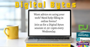 A laptop with a yellow mug to the left. The laptop screen shows the details of the group.